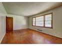 Living room featuring hardwood floors, natural light, neutral paint, and detailed trim providing a relaxing atmosphere at 1815 Windsor Sw Dr, Atlanta, GA 30311