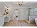 Elegant bathroom with marble walls, wood-look tile floors, a soaking tub, and a glass-enclosed shower at 4030 Scenic View Ct, Cumming, GA 30028