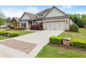 Beautiful brick home with lovely landscaping, a manicured lawn, and a charming entrance makes for great curb appeal at 4815 Amble Trce, Cumming, GA 30040