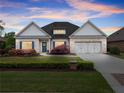 Beautiful brick home with a manicured lawn, blue shutters, and an attached two car garage at 4815 Amble Trce, Cumming, GA 30040