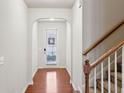 Inviting entryway with hardwood floors and an arched doorway leading to the home's interior at 6595 Story Cir, Norcross, GA 30093