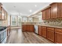 Spacious kitchen featuring stainless appliances, granite counters, and tile backsplash at 548 Myrtle Trace Ln, Suwanee, GA 30024