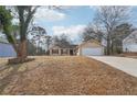 Inviting ranch home with a large driveway and attached garage at 2426 Windridge Dr, Conyers, GA 30013