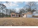 Inviting ranch home with a large driveway and attached garage at 2426 Windridge Dr, Conyers, GA 30013