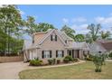 Well-maintained brick house featuring a front yard, driveway, and mature landscaping at 2920 Stanway Ave, Douglasville, GA 30135