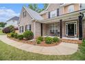 Inviting front porch with black pillars and lush landscaping leading to the front door at 2920 Stanway Ave, Douglasville, GA 30135