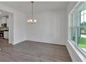 Open dining area with natural light, complemented by the hardwood flooring at 4140 Chapel Hill Reserve, Douglasville, GA 30135