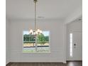 Dining room featuring stylish chandelier and a large window with a view at 4140 Chapel Hill Reserve, Douglasville, GA 30135