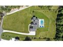 Aerial view of large estate with pool, black fence line, expansive yard and modern farmhouse at 445 Roper Rd, Canton, GA 30115