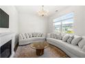 Bright living room featuring a decorative chandelier, fireplace, and hardwood floors at 1961 Vidalia Ct, Dacula, GA 30019