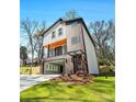 Inviting two-story home featuring a charming porch, a well-maintained lawn, and modern architectural details at 608 S Evelyn Nw Pl, Atlanta, GA 30318