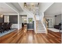 Elegant foyer with hardwood floors, staircase, and views into the dining and living areas at 7545 Brookwood Way, Cumming, GA 30041