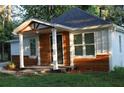 Charming single-story home featuring wood and white accents, a covered porch, and a well-maintained front yard at 2040 Penelope Nw St, Atlanta, GA 30314