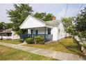 Quaint single-story house with a covered front porch and neat landscaping at 27 Hazel St, Porterdale, GA 30014