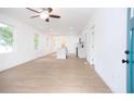 Open-concept living space showcasing light wood floors and an airy ambiance at 27 Hazel St, Porterdale, GA 30014