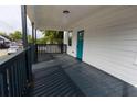 Covered porch with painted wood floors and railings, leading to the front door at 27 Hazel St, Porterdale, GA 30014