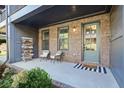 Inviting front porch with chairs, decorative touches, and a stylish entrance door at 6775 Pippin Walk, Alpharetta, GA 30005