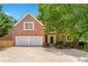 Attractive brick home with a two-car garage, well-maintained landscaping, and a welcoming entrance at 4746 Chamblee Dunwoody Rd, Atlanta, GA 30338