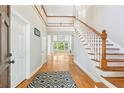 Grand foyer with hardwood floors, staircase, and an open view to the living area at 4746 Chamblee Dunwoody Rd, Atlanta, GA 30338