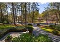 Picturesque backyard view with mature trees, lush landscaping, and a tranquil pond at 3 Demorest Ne Ave, Atlanta, GA 30305