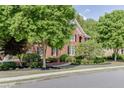 Charming brick home with black shutters, manicured landscaping, and mature trees at 3284 Bakers Mill Ct, Dacula, GA 30019