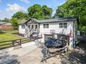 Charming exterior view featuring a boat on the drive, a well-manicured yard and a 2-car garage at 369 Arnold Mill Rd, Woodstock, GA 30188