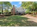 Expansive backyard featuring a large lawn and a deck perfect for outdoor entertaining at 5620 Preserve Cir, Johns Creek, GA 30005