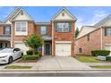 Charming brick townhome featuring an attached one-car garage and professionally landscaped surroundings at 5654 Lawley Dr, Alpharetta, GA 30022