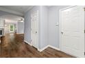 Open hallway features wood-look flooring with a view into the main living area with fireplace at 5654 Lawley Dr, Alpharetta, GA 30022