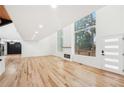 Bright and airy living room featuring hardwood floors, a fireplace, and large windows offering beautiful views at 2396 Sunset Ne Dr, Atlanta, GA 30345