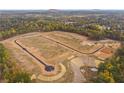 Aerial view of new construction site surrounded by lush trees, revealing multiple homesites at 294 Pickens Bluff Ln, Hiram, GA 30141