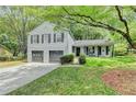 Charming two-story home with a two-car garage, landscaped yard, and covered front porch at 655 Barrington Way, Roswell, GA 30076