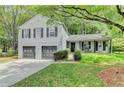 Charming two-story home with a two-car garage, landscaped yard, and covered front porch at 655 Barrington Way, Roswell, GA 30076