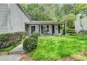 Inviting covered front porch with seating, plants, and a well-maintained lawn at 655 Barrington Way, Roswell, GA 30076