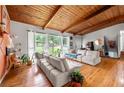 Spacious living room offers an open floor plan and large windows with natural light and hardwood floors at 1188 Cedar Park Cir, Stone Mountain, GA 30083