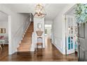 Bright foyer with hardwood floors, staircase, elegant chandelier and a beautiful entry door at 4257 Edgewater Nw Dr, Kennesaw, GA 30144