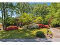 Charming brick home with a well-manicured lawn and lush landscaping at 3200 Turtle Lake Se Ct, Marietta, GA 30067