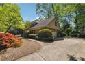 View of the brick home showing the side driveway and garage at 3200 Turtle Lake Se Ct, Marietta, GA 30067