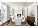 Dining room features a chandelier, fireplace, and elegant white chairs at 3370 Habersham Nw Rd, Atlanta, GA 30305