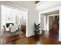 Bright foyer leading to dining room with chandelier and hardwood floors at 3370 Habersham Nw Rd, Atlanta, GA 30305