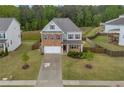 Two-story home featuring brick and cement board siding, a well-maintained lawn, and a two-car garage at 3510 Meadow Grass Dr, Dacula, GA 30019