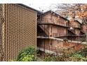 Multi-story building featuring a red brick exterior, balconies, and staircases, surrounded by trees and landscaping at 120 Alden Nw Ave # D2, Atlanta, GA 30309
