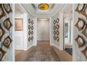Elegant hallway featuring wood floors, decorative mirrors, custom lighting, and inviting entryway at 3344 Peachtree Ne Rd # 3601, Atlanta, GA 30326