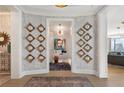 Inviting foyer featuring custom wall decor, hardwood floors, and an open view to the living area at 3344 Peachtree Ne Rd # 3601, Atlanta, GA 30326