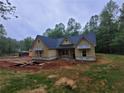 Front exterior of new construction house with board and batten siding, featuring a dark roof, windows, and front porch at 879 Highway 101 N, Dallas, GA 30157
