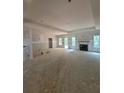 Large unfinished living room with fireplace and multiple windows at 879 Highway 101 N, Dallas, GA 30157