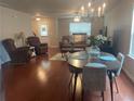 Inviting living room with hardwood floors, a cozy seating area, and ample natural light at 487 Cypher Dr, Suwanee, GA 30024