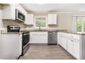 Galley kitchen with granite countertops, stainless steel appliances, and white cabinetry at 535 Transit Cir, Atlanta, GA 30349