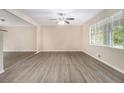 Spacious living room with large window and modern plank flooring at 535 Transit Cir, Atlanta, GA 30349