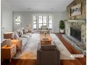 Bright living room with a stone fireplace, large bay window, and hardwood floors at 1950 Matthew Way, Lithonia, GA 30058